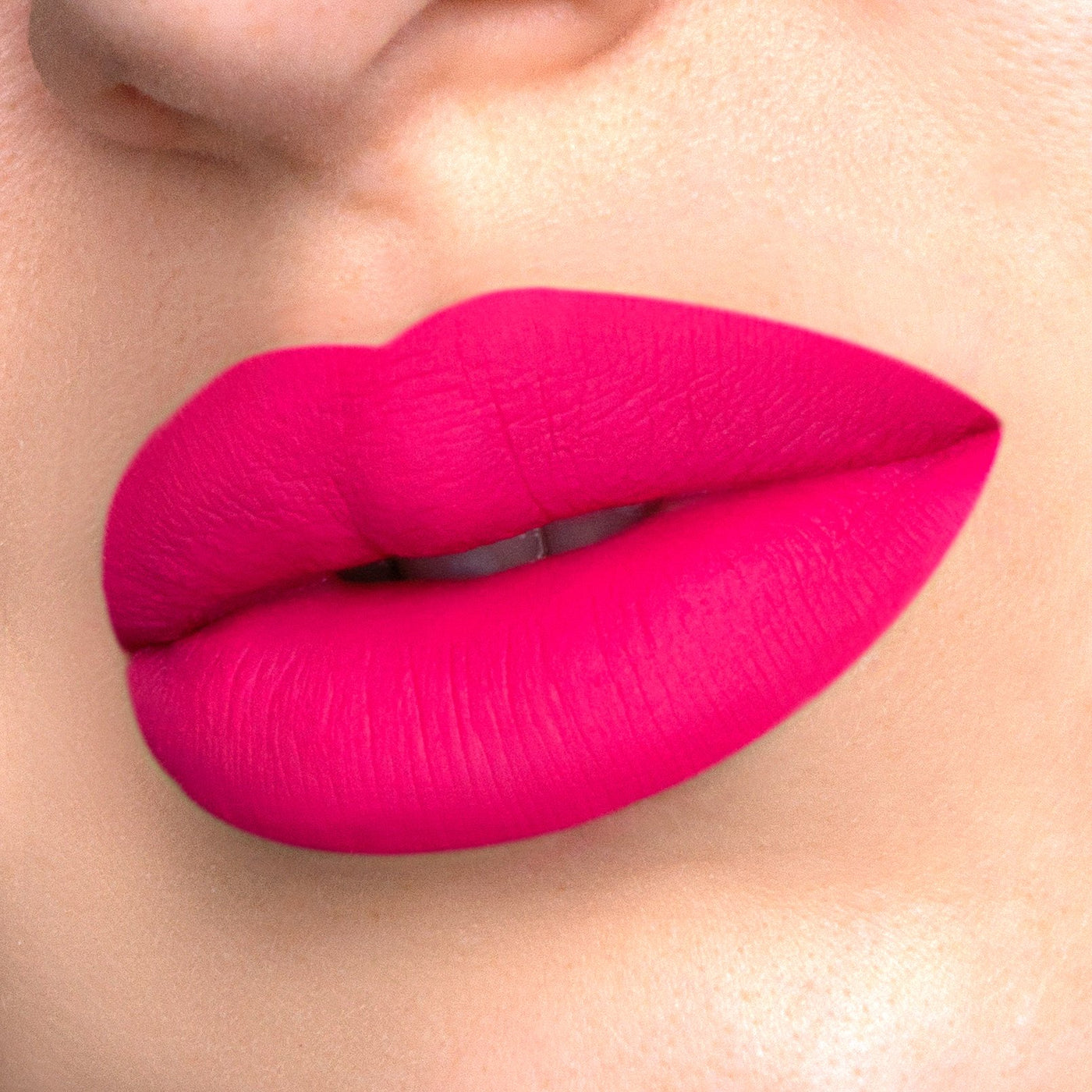 Fantasy a hot pink liquid lipstick swatched on model