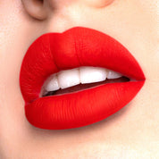 Romance a bright red liquid lipstick swatched on model